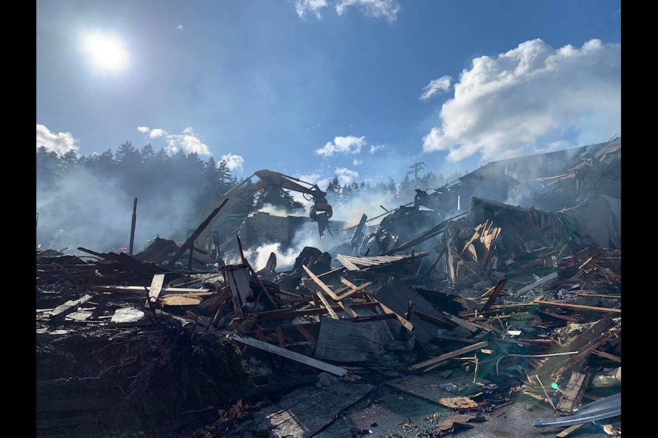 An excavator breaks up debris looking for hot spots at the scene of a fire at the old Pioneer Square Mall building in Mill Bay on Friday, May 27, 2022. (Photo courtesy of Mill Bay Fire Rescue)
