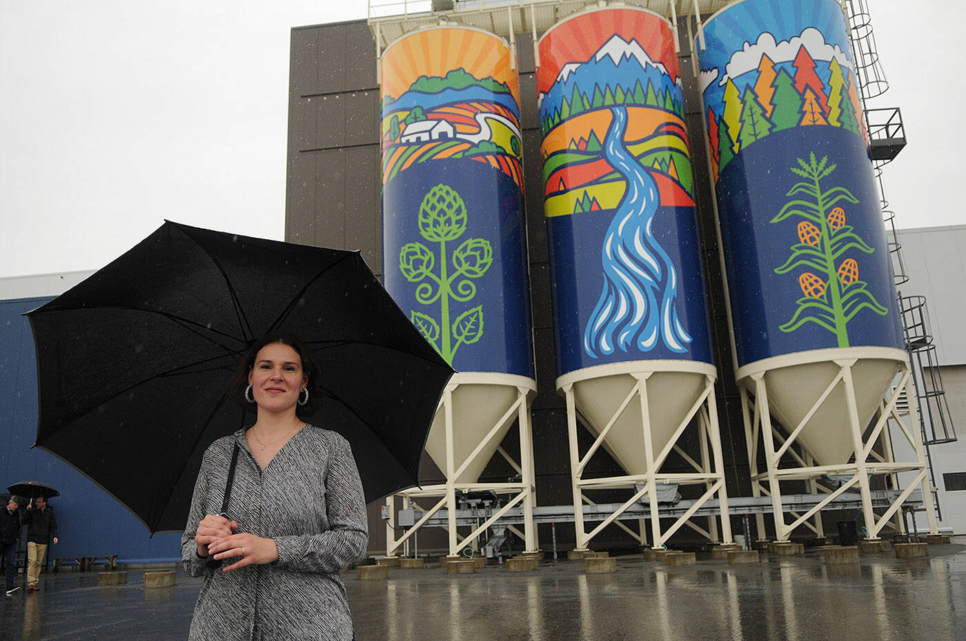 Chilliwack artist Silvana Kulyk stands in front of her public art piece Gifts of Nature which was installed on silos outside the Molson Coors Fraser Valley Brewery and unveiled on Thursday, June 9, 2022. (Jenna Hauck/ Chilliwack Progress)