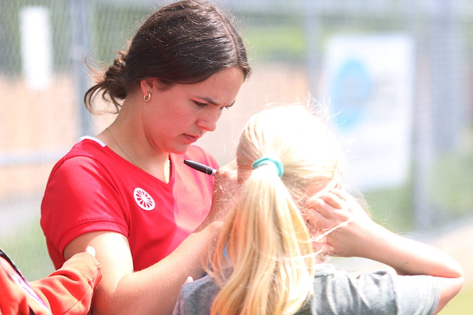 Duncan product and national team member Sara Goodman signs autographs for young fans during a field hockey camp at the Cowichan Sportsplex last Sunday. (Kevin Rothbauer/Citizen)