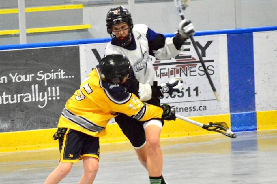 Joel Perret charges into a Comox defender during the Cowichan Thunder’s Island final game at Kerry Park Arena last Sunday. (Paula Harris photo)