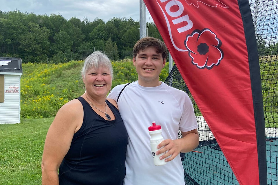 Connor Hengstler stands with his mom and coach, Julia Hengstler, at the Legion National Track and Field Championships in Sherbrooke, Quebec. (Submitted by Julia Hengstler)