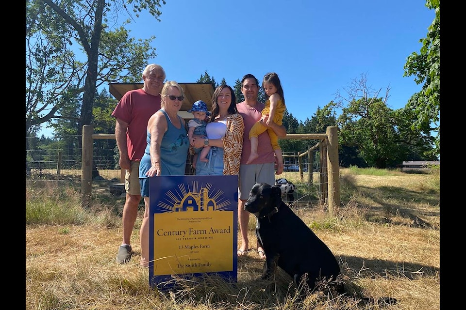 Generations of the Smith family have been farming in the Cowichan Valley since 1897. They were recently recognized with the Century Farm award celebrating 100 years of farming. Posing in front of their goat pen is Michael K. (left) and his wife Sheila, Michael D.’s wife Courtney holding their son Michael J., Michael D. holding their daughter Charlotte, and Lucky the family dog. (Chadd Cawson/Citizen)