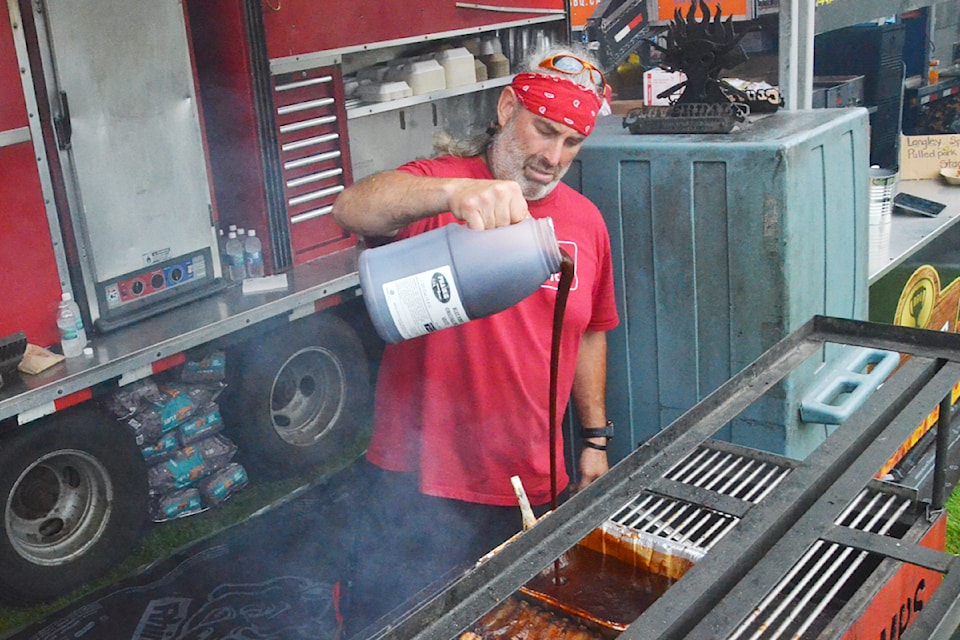 Glen Cherlet of Prairie Smoke & Spice poured barbecue sauce at  RibFest on Friday, Aug. 16.