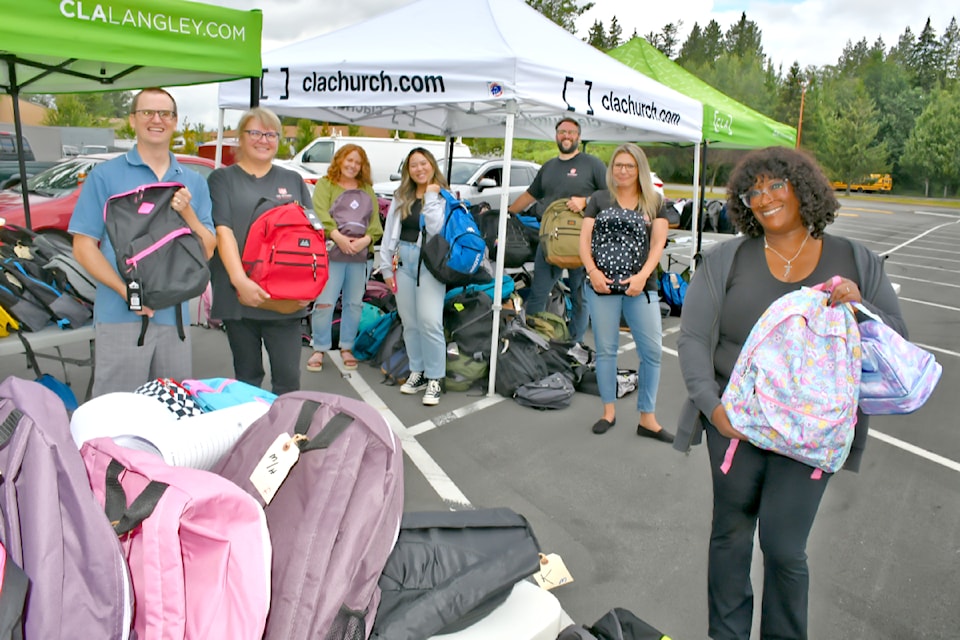 (Left to right) Dan Donkers, Andréa Voss, Mandy Martens, Mary Phommaviset, Justin Napier, Julie Gilfillan, and Rachel Martin assembled more than 700 backpacks on Tuesday, Aug. 20, 2024. 