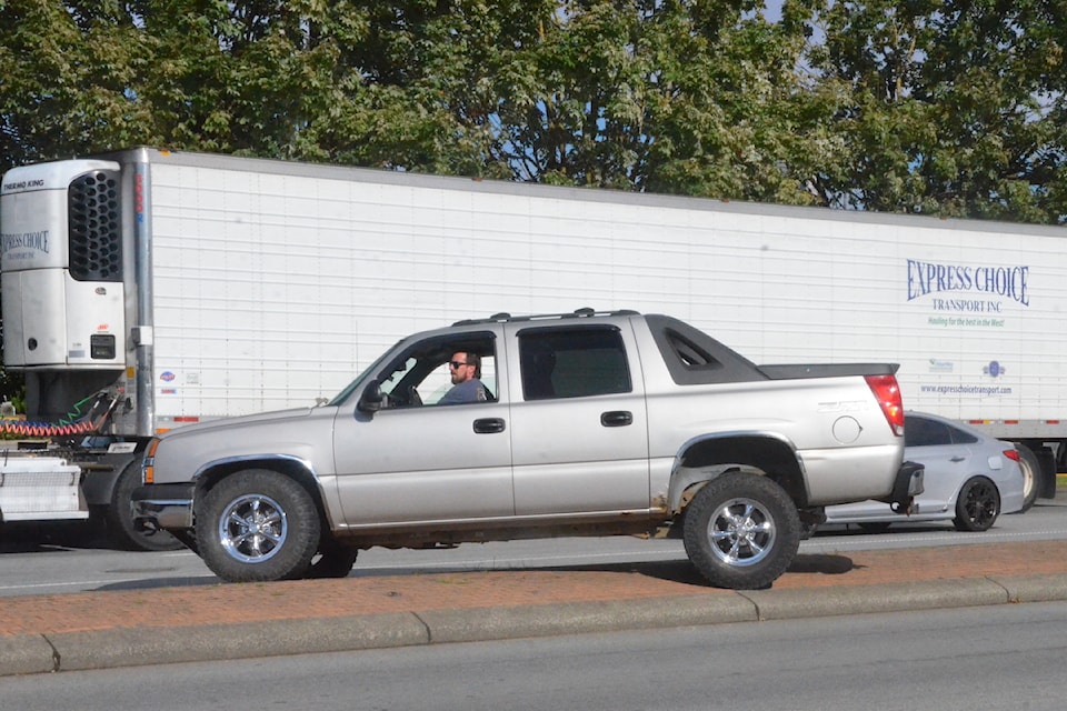 A driver backed over the median on 200 Street to get away from the train crossing after 'mechanical issues' halted a freight train, blocking traffic Monday morning, Aug 19.