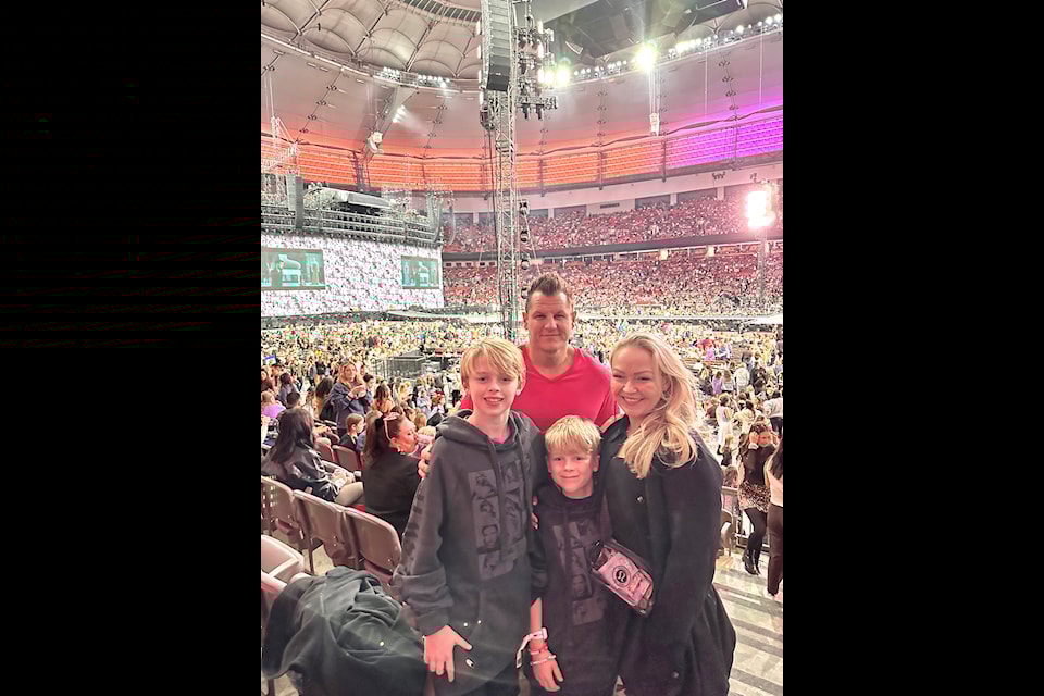 Kelsey Carignan, with husband Ryan and sons Noah (left) and Holden at the Taylor Swift concert on Sunday, Dec. 8. 'We had the mist incredible time!' she said.