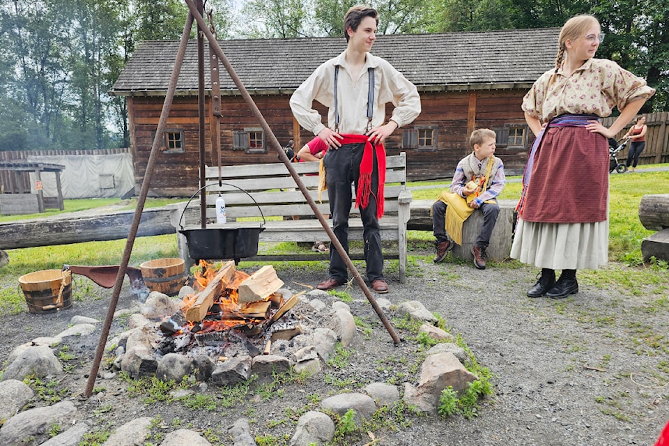 Historical re-enactors built a wood fire on Canada Day at historic Fort .