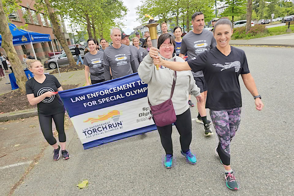 Special Olympics competitor Andrea Zonneveld (left) was the first to carry the torch, with officer Const. Lisa Cormier (right), as the 91ԭ torch run fundraiser got going on Wednesday, June 12 at the RCMP detachment.