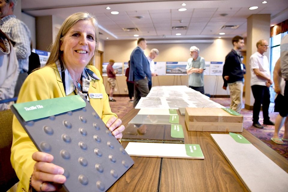 Jennifer MacLean, associate vice president overseeing the project, showed some of the materials used at SkyTrain stations. (Heather Colpitts/91ԭ Advance Times)