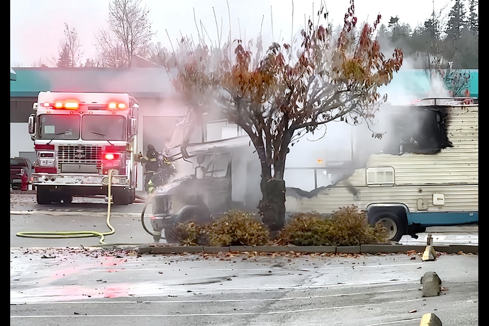 A burning RV in a parking lot sent a plume of smoke high into the air Saturday morning in 91ԭ.