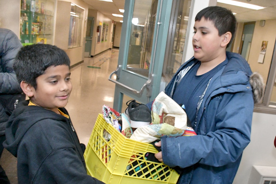 Students of teacher Jasvinder Dhesi carried donations from their classroom to Kimz Angels vehicle. The students wanted to do something to help local unhoused people and gathered up items they can use. 
