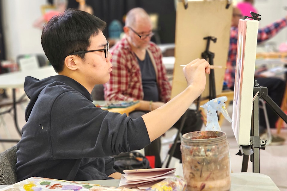 Nine artists were creating images of three models at the 91ԭ Arts Council portrait competition last year.