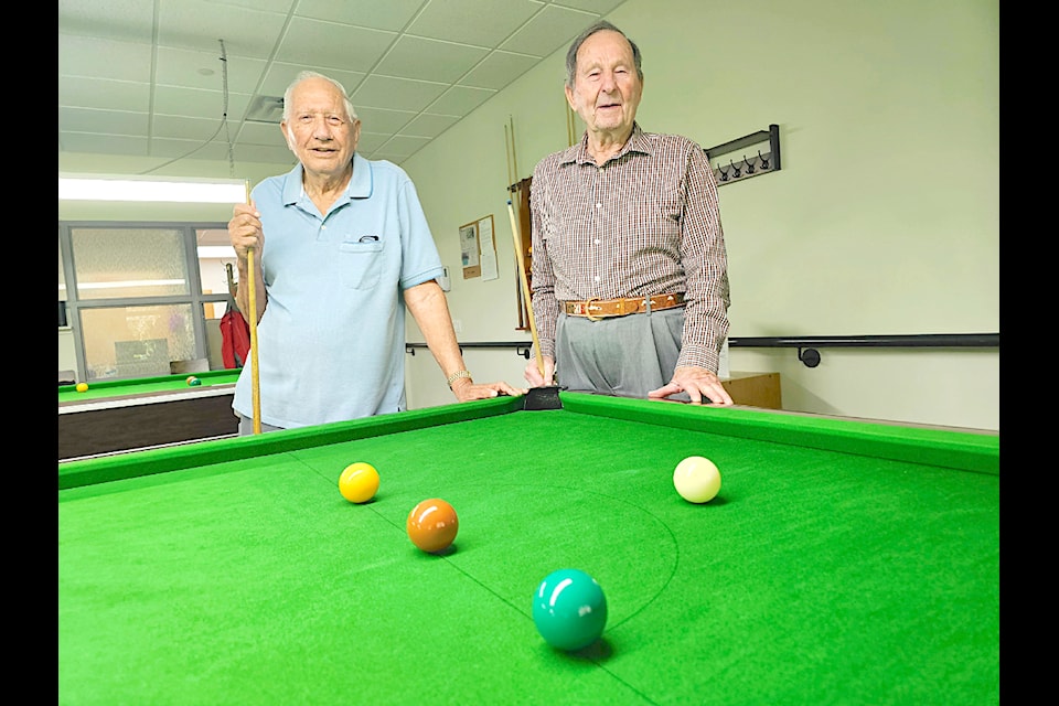 Bob Dumont, 86, (left) and Nick Schiller, 90, (left) are some of the most experienced players at the  Seniors Resources Society centre snooker room. 