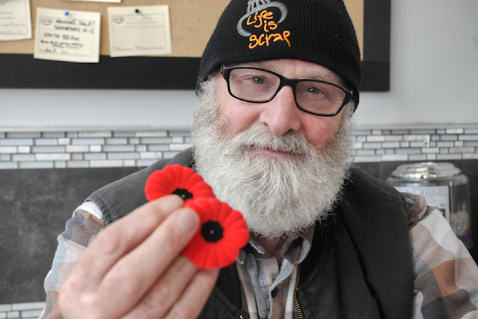 Randy Twiss is one of the volunteer poppy taggers this year. He was set up at the Otter Co-op on Oct. 31, 2024. 