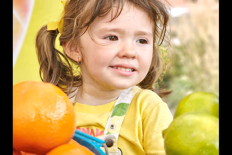 Esmeralda, 3, from New Westminster, seen here at the fresh produce stand,  was among the hundreds who attended the first Carnavalito on the Road: Fraser Valley Edition at 91ԭ City's Douglas Park on Saturday, Sept. 7.