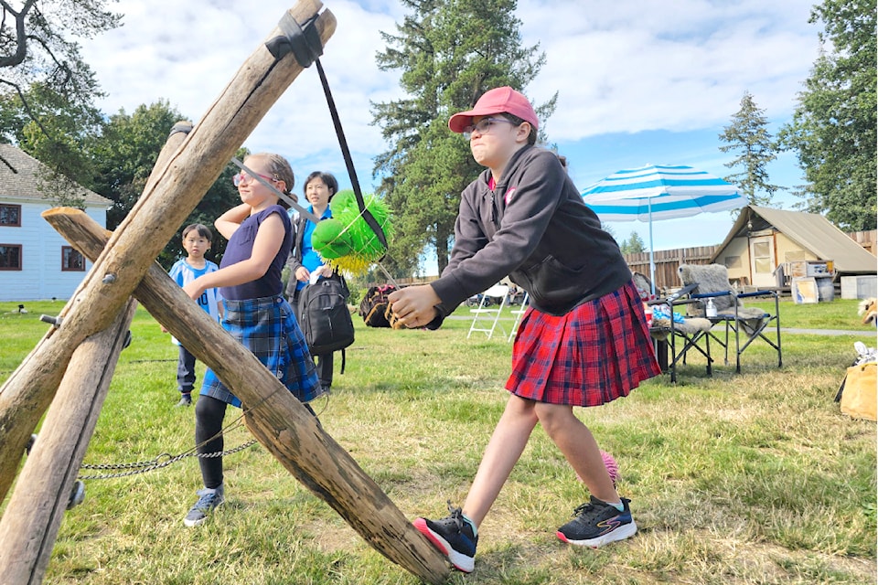Playing a Metis game, children took aim at a target on Saturday, Sept. 21 during a celebration of the multicultural legacy of Sir James Douglas, the first governor of British Columbia