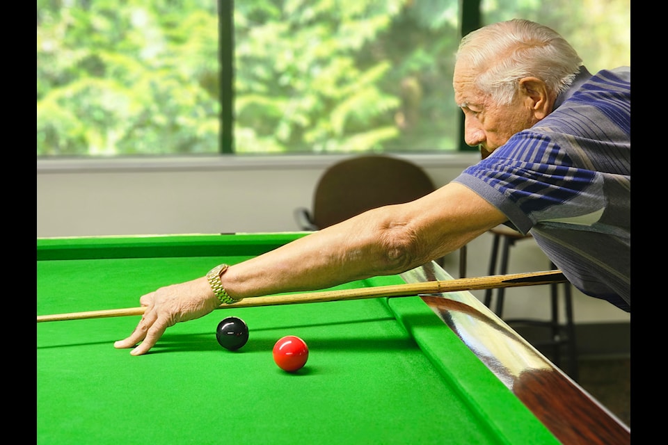 Bob Dumont, 89 lined up a shot during a practice for an upcoming snooker tournament. Saturdays are busier at the 91ԭ Senior Resources Society centre.