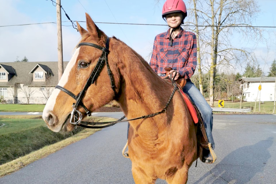Madissyn Bryce with Griffin on 246 Street, near 51 Avenue, would be impacted by the proposed Township bylaw change restricting horses on local streets.