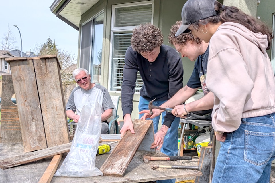 Larri Woodrow looked on and gave instructions to the students building wood duck boxes on March 31.