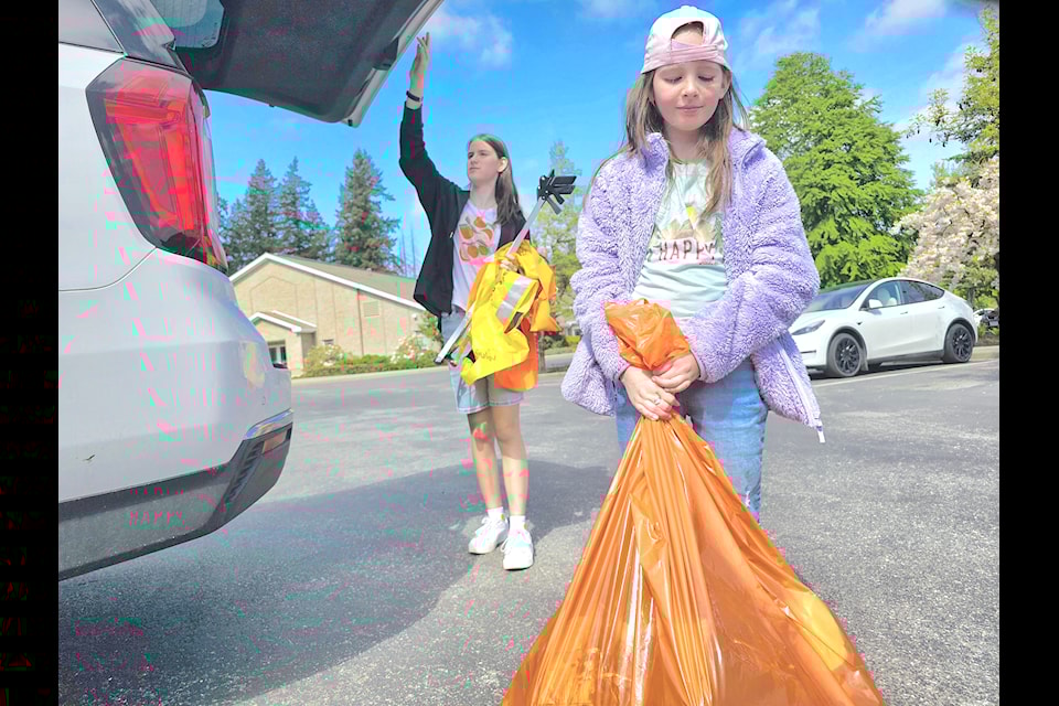 Young volunteers returned with trash to the collection site at the Church of Jesus Christ of Latter-day Saints at 20030 82 Ave.on Saturday, April 26.