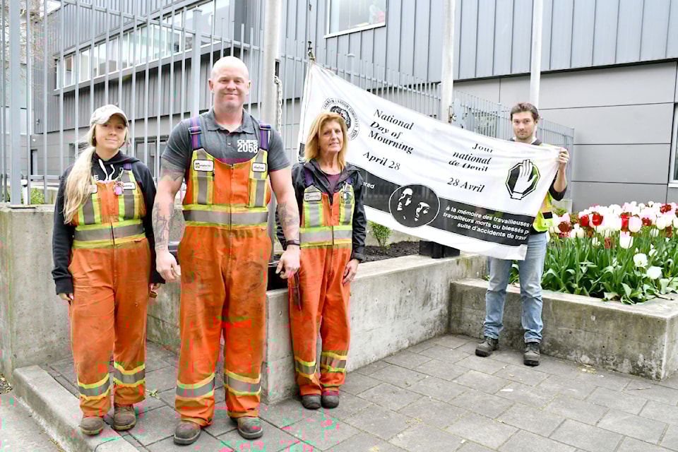 91ԭ City workers Lindsey Harden Andrew March, the union local president; Judy Gulbransen; and Colten Burr attended the memorial ceremony for workers killed or injured on the job. 