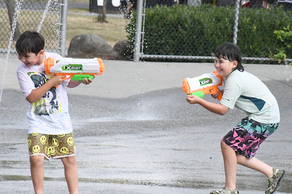 Siblings Noah Barton, left, and Aria Barton, right, took part in the annual Community Water Fight at the spray park in Willoughby on Thursday, Aug. 7.