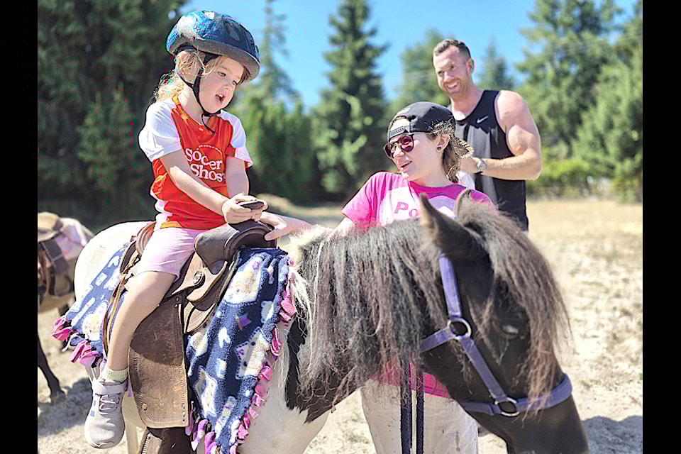Millie, 4, from Campbell Valley enjoyed a ride on pony Oreo as the Artful Dodger pub in Brookswood hosted its first family fun day.