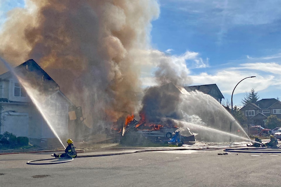 Fire crews worked to extinguish the fire that damaged at least one adjacent home.