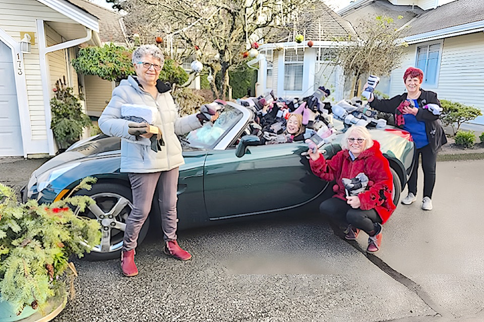 A 91ԭ seniors sock donation drive set a new record. Volunteers Margaret McKeigan (left), Arabella Genge (in car) Bev Genge and Phyllis Lusk (right) were smiling.