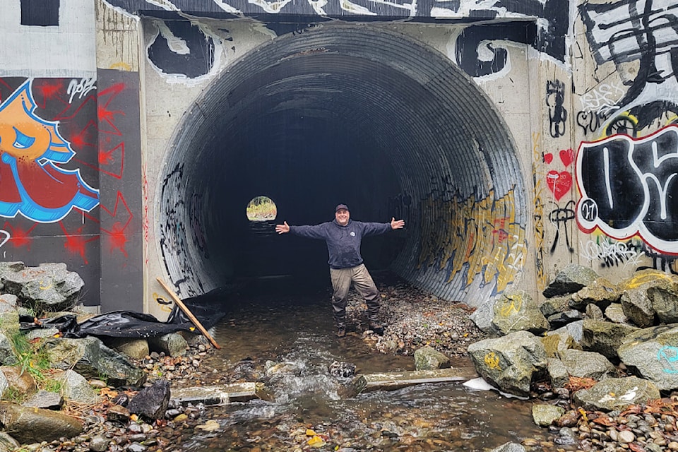 Nat Cicuto stands in the fish-friendly culvert under Highway #1 at Yorkson Creek.
