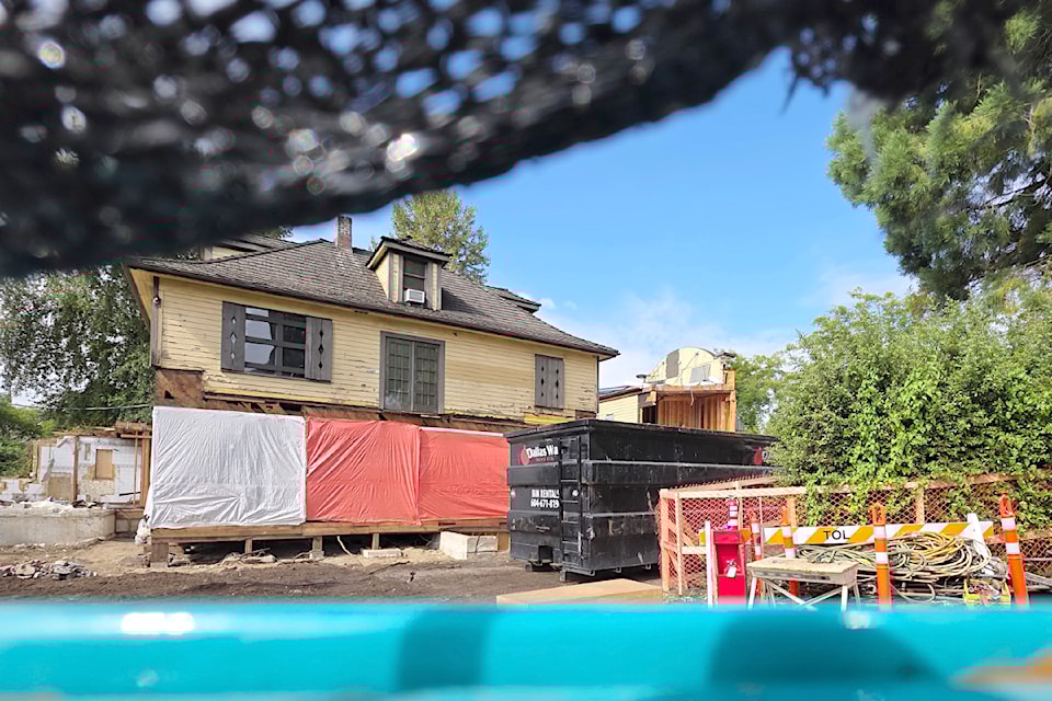 Fort 91ԭ's historic Haldi house is viewed through a gap in a construction safety fence. It  will move onto a new foundation in early August, a Township update said.