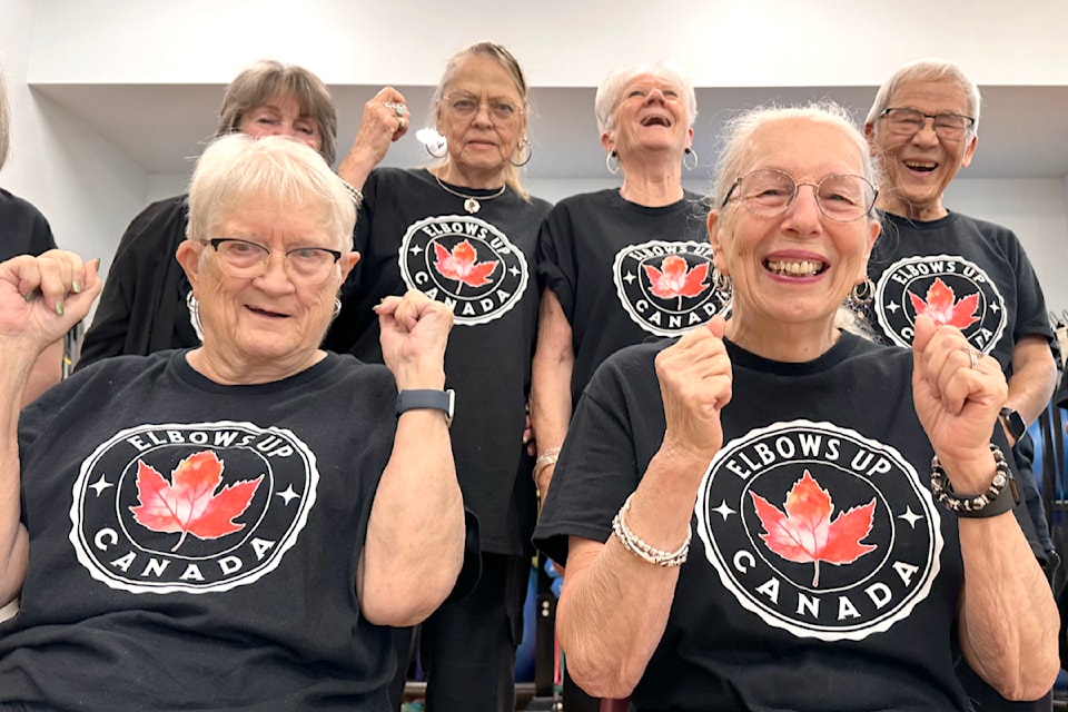 A group of men and women taking a GentleFit classes at Timms Community Centre with Sue O. on Tuesdays and Thursdays, all purchased Elbows Up, Canada! T-shirts from one of the participants. They then posed together in support of a grassroots movement bringing people together to stand strong the values that define us as Canadians. Started in hockey, the Elbows Up concept was started to demonstrate strength and determination in the face of adversity.