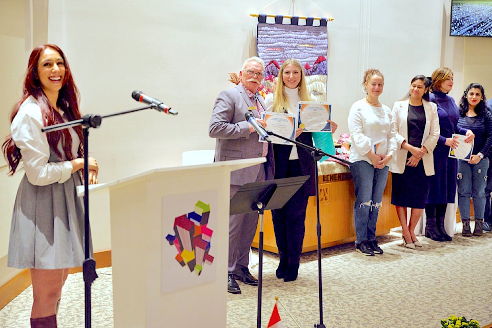 Charndeep Chattu, the LINC 7.8 language teacher, presented New Directions graduation certificates to her class, assisted by 91ԭ City Councillor Paul Albrecht. With him is the winner of the writing contest, Svitlana. 