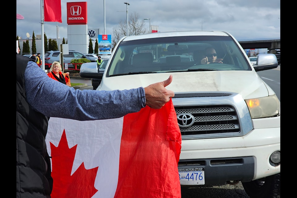 About a dozen picketers demonstrated outside the Tesla dealership on the Langley bypass Saturday, March 22, 2025.
