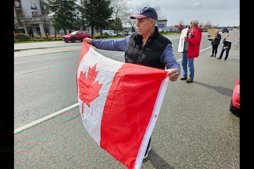 About a dozen picketers demonstrated outside the Tesla dealership on the 91ԭ bypass Saturday 