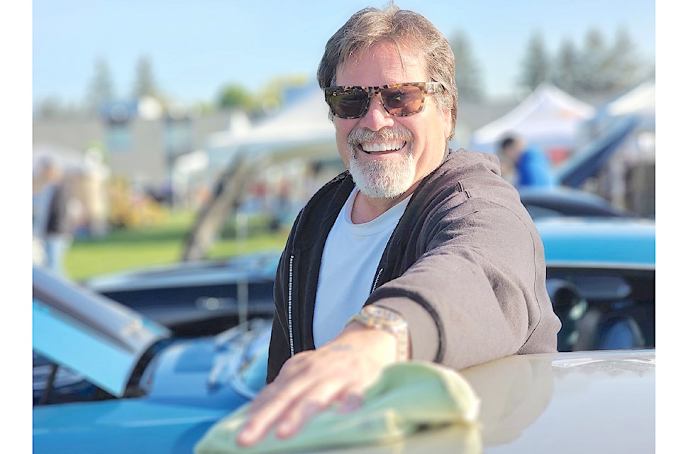 A car owner was doing some polishing at the D. W. Poppy car show and fundraiser.