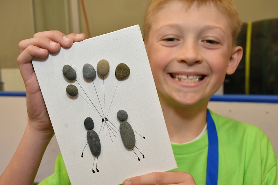Hayden Turner used smooth rocks to create a variety of art pictures for his Rockin' It Designs booth at the IDEA Summit on May 6, 2025. 