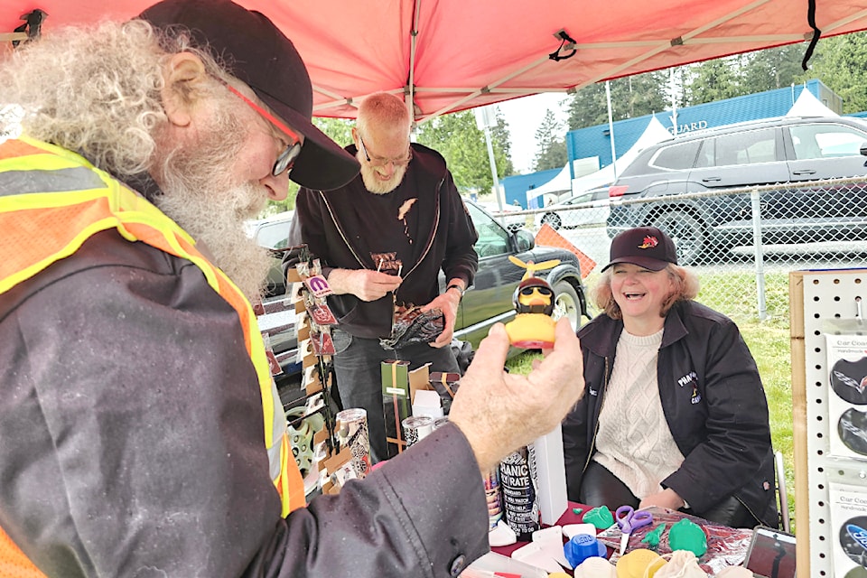 Steve Williams, president of the Fraser Valley chapter of the Pharaoh's Car Club, the oldest car club in North America, shared a laugh with some vendors at the Vanguard School car show in early 2025.