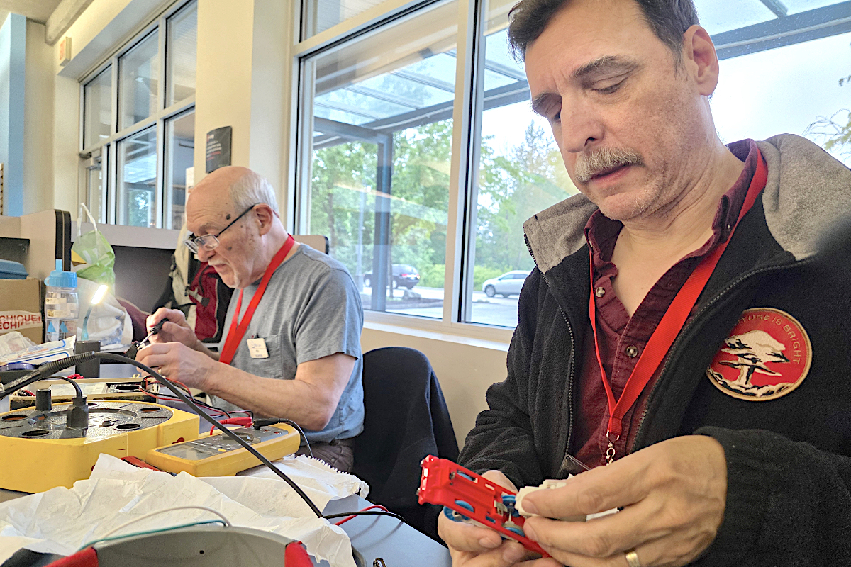 People fixing items at repair cafe
