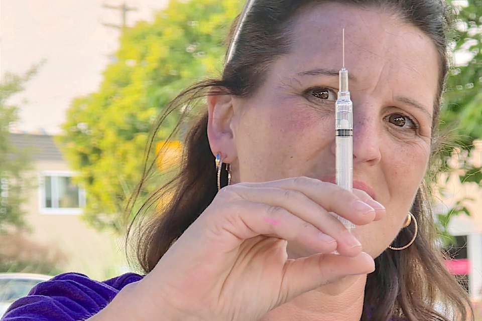Outreach worker Rosie Rurka was demonstrating how to use Naloxone and other harm reduction resources to save lives at Douglas Park as  City marked International Overdose Awareness Day.