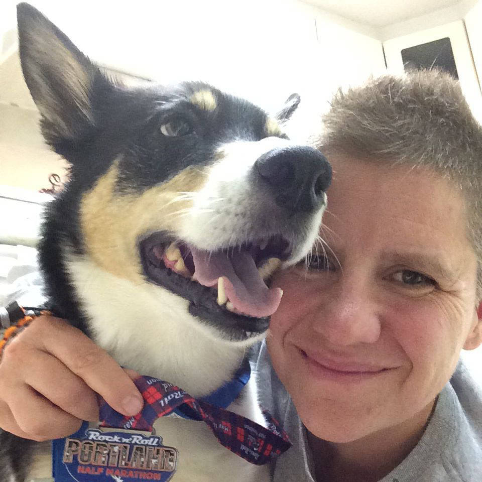 Alice Fox/Facebook RCMP member Alice Fox with her dog Jasper, holding a medal from the Rock 鈥榥鈥 Roll Portalnd half marathon. To deal with her PTSD, Cloverdale resident Alice Fox ran a marathon a week in 2015. The medals are hanging up on her apartment wall.