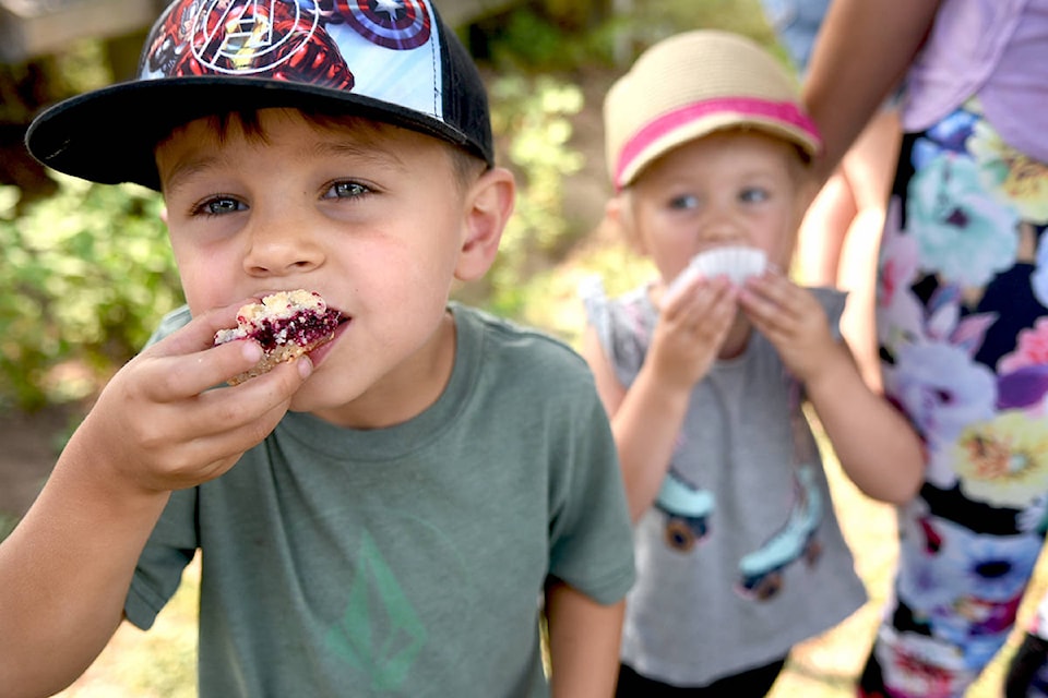 Luke Cleaveley, 4, and his sister Norah, 2, enjoy some samples of the blackberry treats at the annual Blackberry Bake-Off on Aug. 15. Miranda Gathercole Langley Times