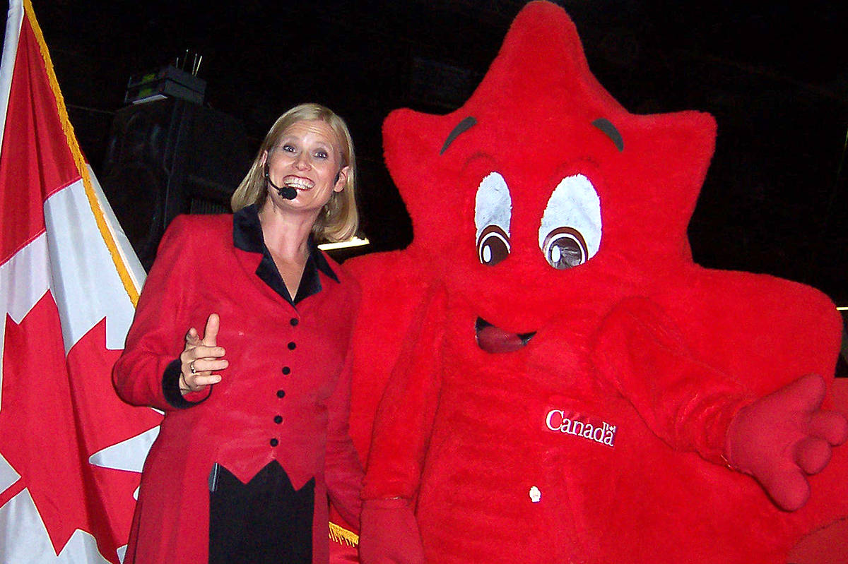 8720970_web1_Judi-at-PNI-Canada-Pavilion-with-Canada-Flag-mascot