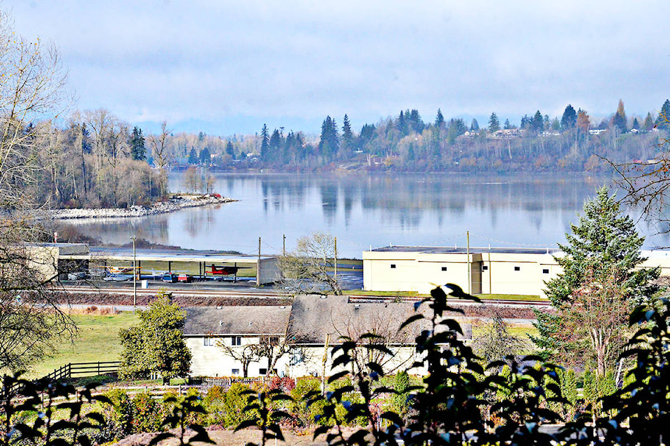 The view of the Fraser River and the eastern side of McMilland Island from Armstrong Road which goes up onto a bluff just off River Road. At the river’s edge is the Fort 91ԭ Airport. 