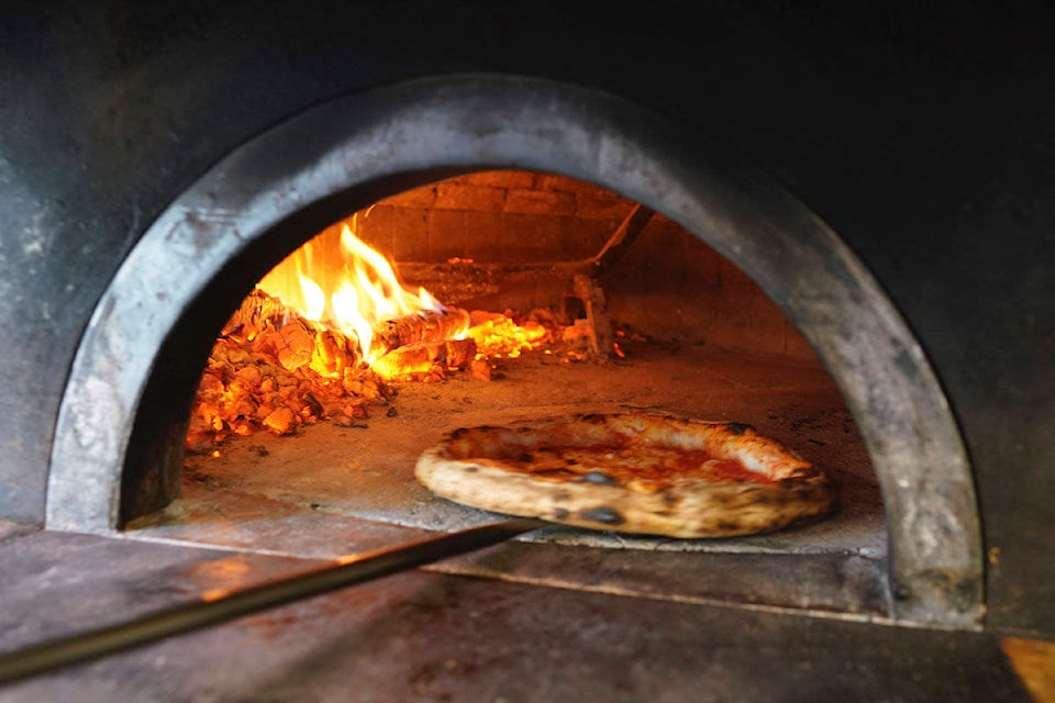 Pizzas are being prepared for home delivery at the Caputo pizzeria in Naples, Monday, April 27, 2020. Region Campania allowed cafes and pizzerias to reopen for delivery Monday, after a long precautionary closure due to the coronavirus outbreak. (AP Photo/Andrew Medichini)