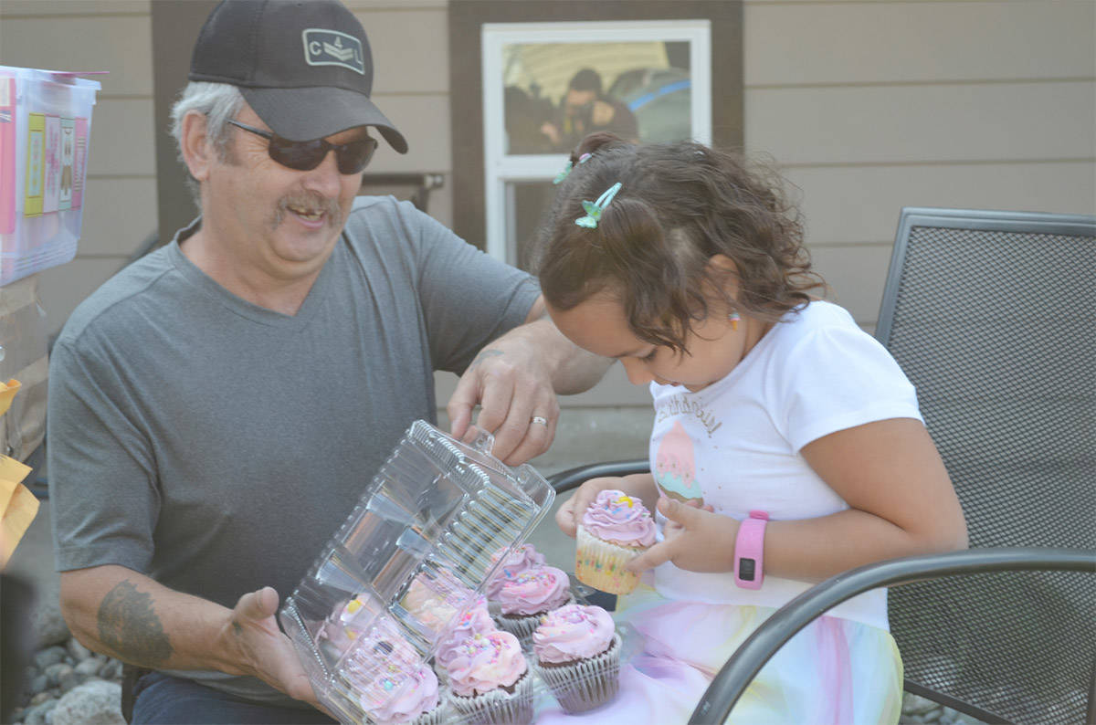 Charlie Manning, 6, and grandpa Ray dig into some Sweet Spot Cupcakes, delivered to their Kamloops, B.C., home on Charlie鈥檚 birthday 鈥 Aug. 13. They were ordered by a woman in Montreal who answered a social media request from Charlie鈥檚 aunt for people to help her niece celebrate her COVID-restricted birthday. (Michael Potestio/KTW)