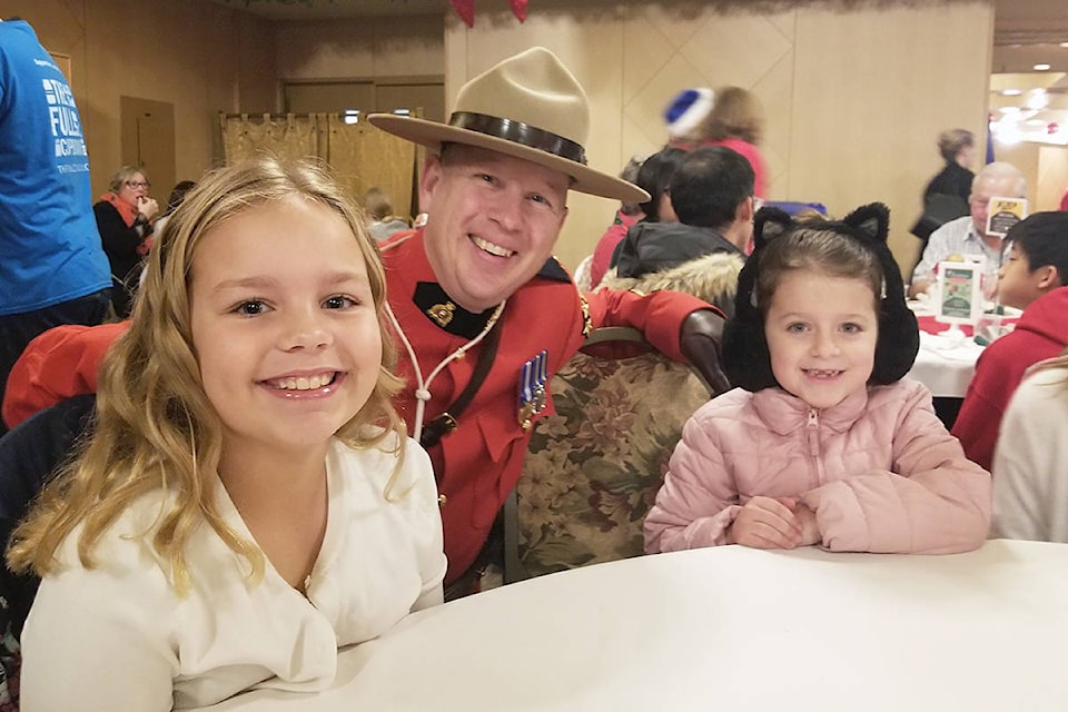 Langley RCMP Cpl. Craig van Herk and two young friends got up early to attend last year’s third annual Christmas Wish Breakfast toy drive and fundraiser at Newlands Golf & Country Club. This year, due to the pandemic, the breakfast has been cancelled, instead the Langley Christmas Bureau is accepting gift cards or donations online or in-person at Langley City Hall. (Langley Advance Times file)