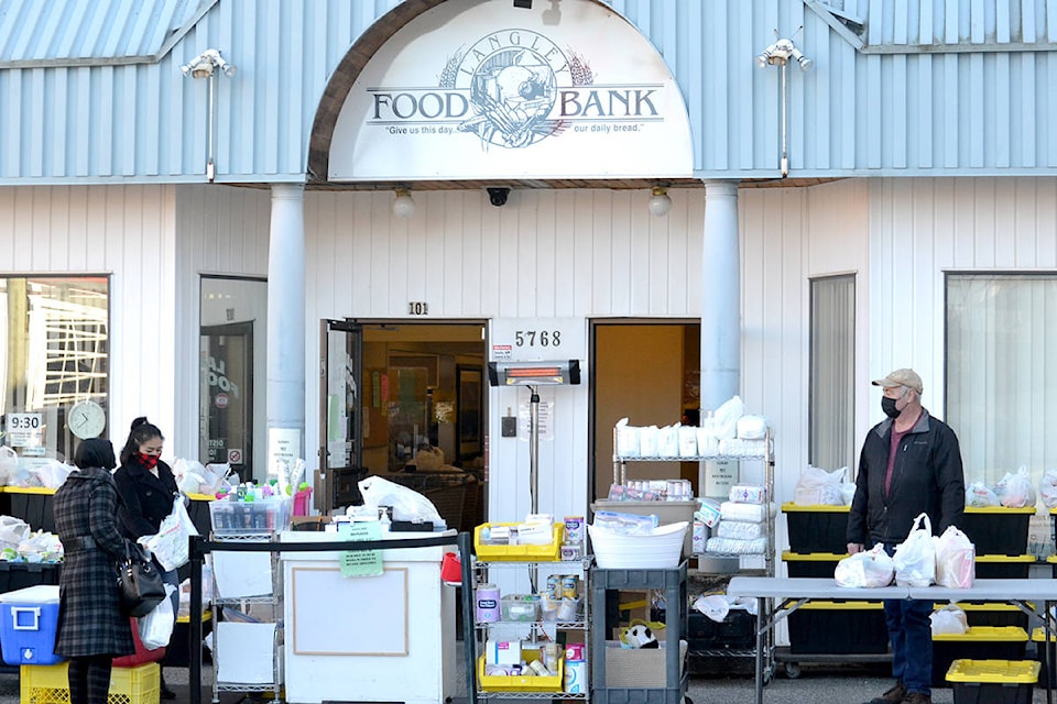 Volunteers at the Langley Food Bank have set-up distribution outside in the parking lot so clients can safely distance. (Ryan Uytdewilligen/Black Press Media)