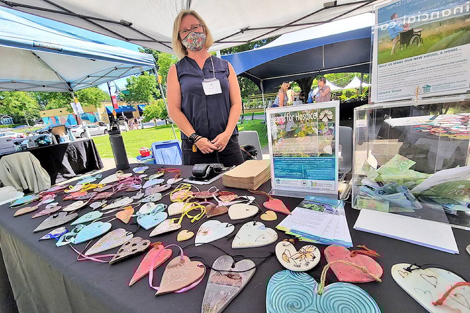 Shannon Todd Booth, the 91ԭ Hospice Society communication and funds manager, with some of the ceramic hearts on sale at Saturday’s fundraiser at the Fort 91ԭ Community Hall. (Dan Ferguson/91ԭ Advance Times)