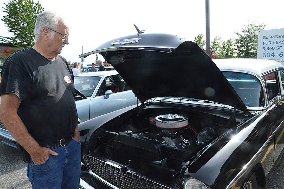 Pat Bolton showed off the engine to his Bel Air, a fully restored creation he recently bought. (Matthew Claxton/Langley Advance Times)